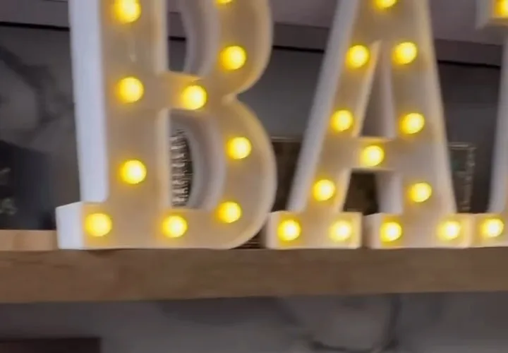 Light-up marquee letters spelling BAR above the trailer back counter